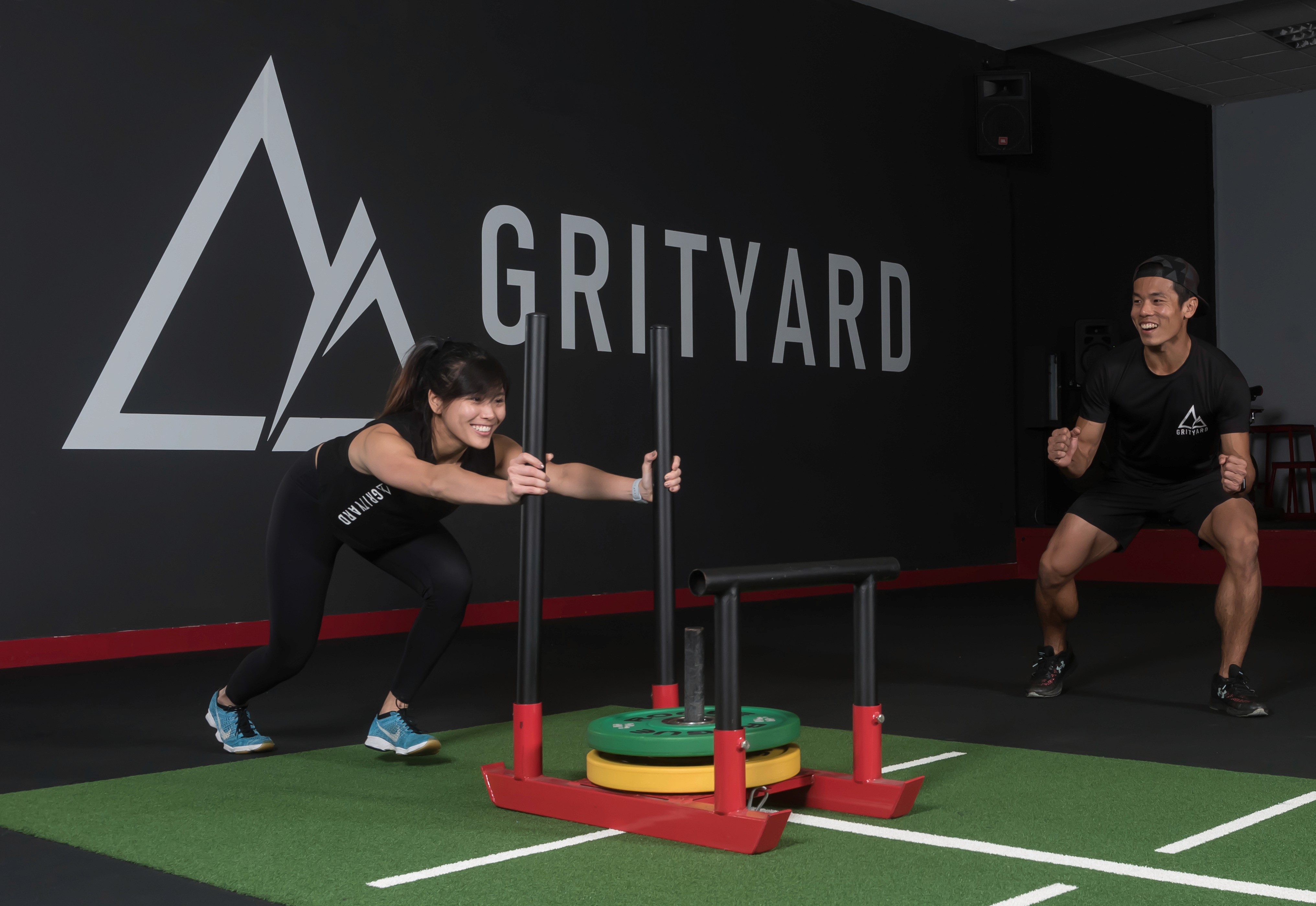 Athletes performing sled push training at GRITYARD Geylang